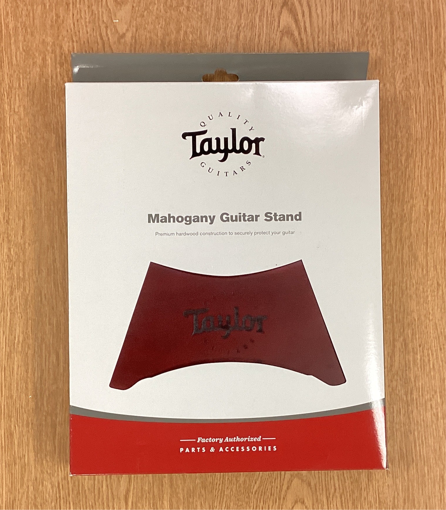 Taylor Mahogany Guitar Stand packaging on a wooden surface