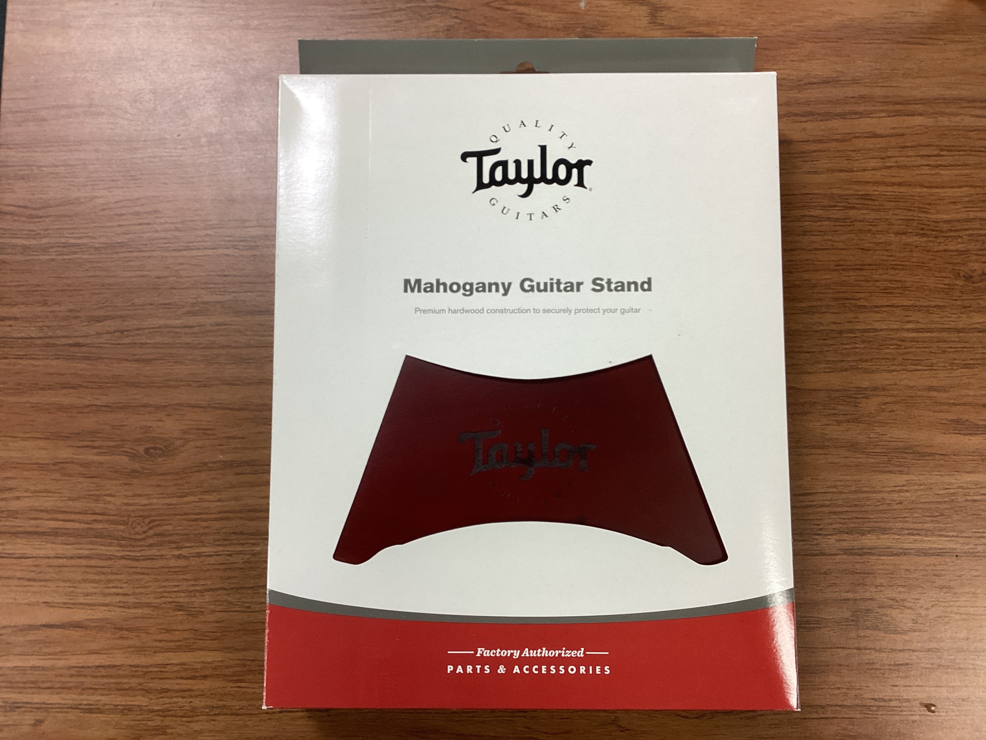 Taylor Mahogany Guitar Stand packaging on a wooden surface