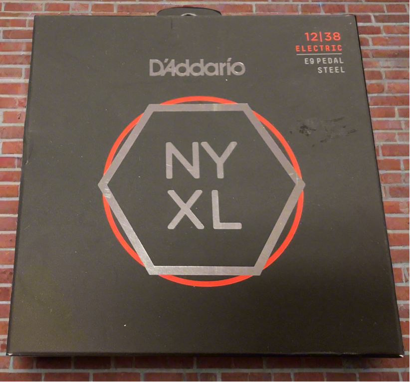 Image of A boxed set of D'Addario NYXL electric guitar strings, with the brand logo visible on the packaging.