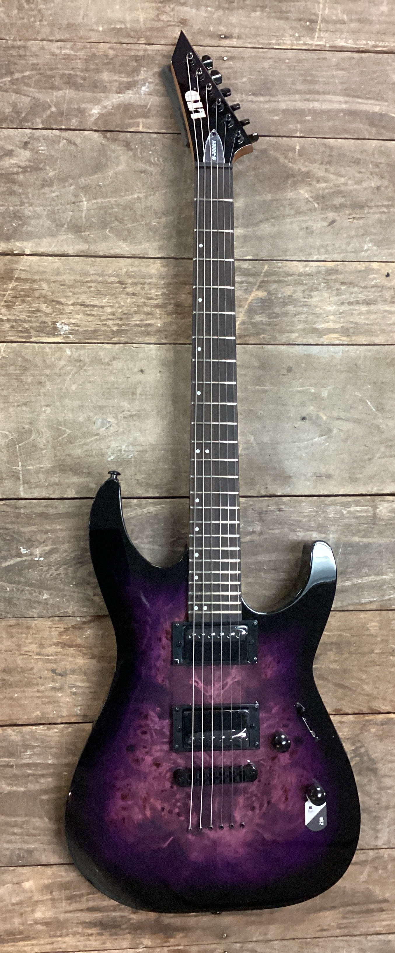 Image of Purple electric guitar on a wooden surface