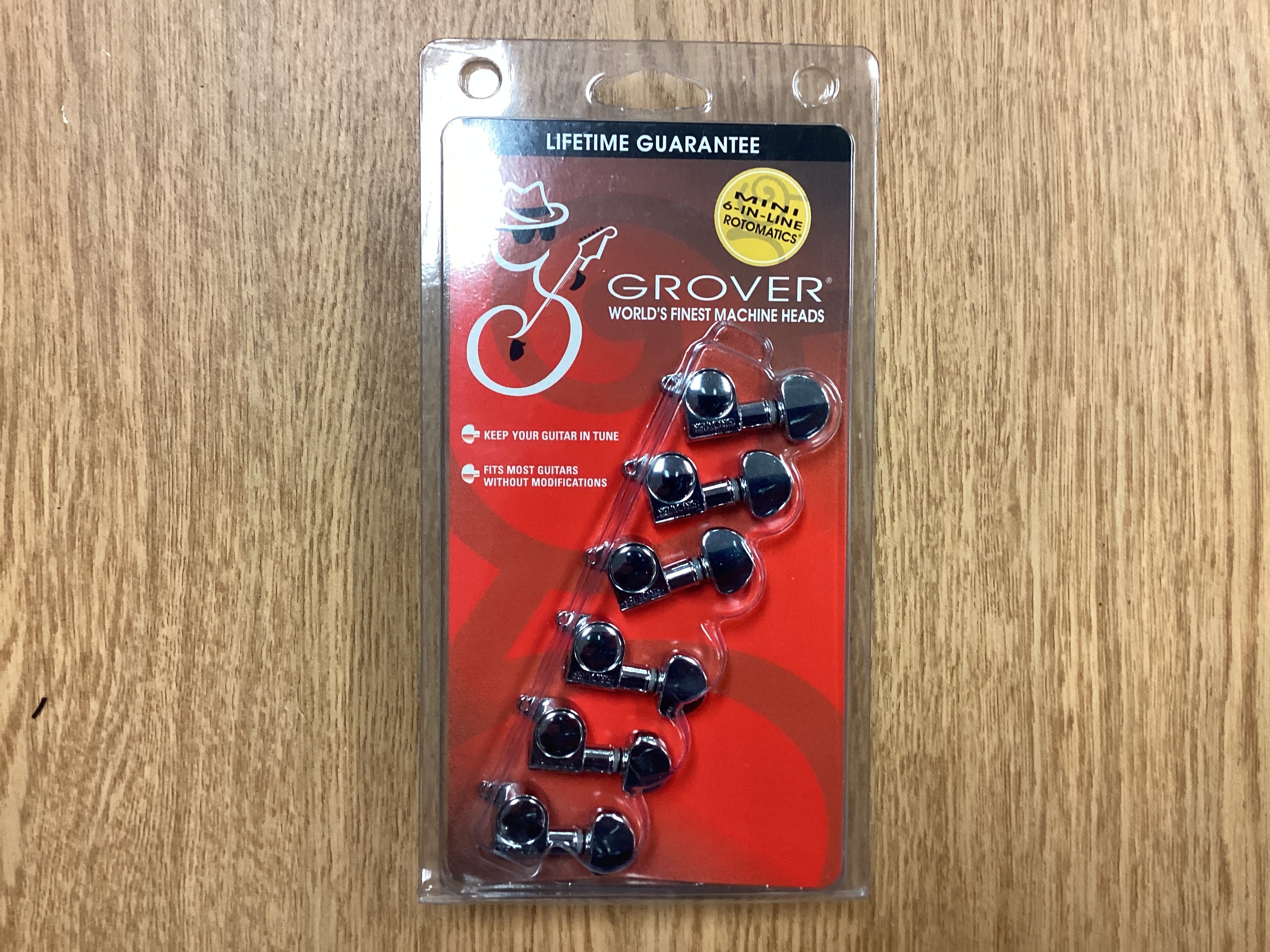 Image of Packaged Grover guitar machine heads on a wooden surface