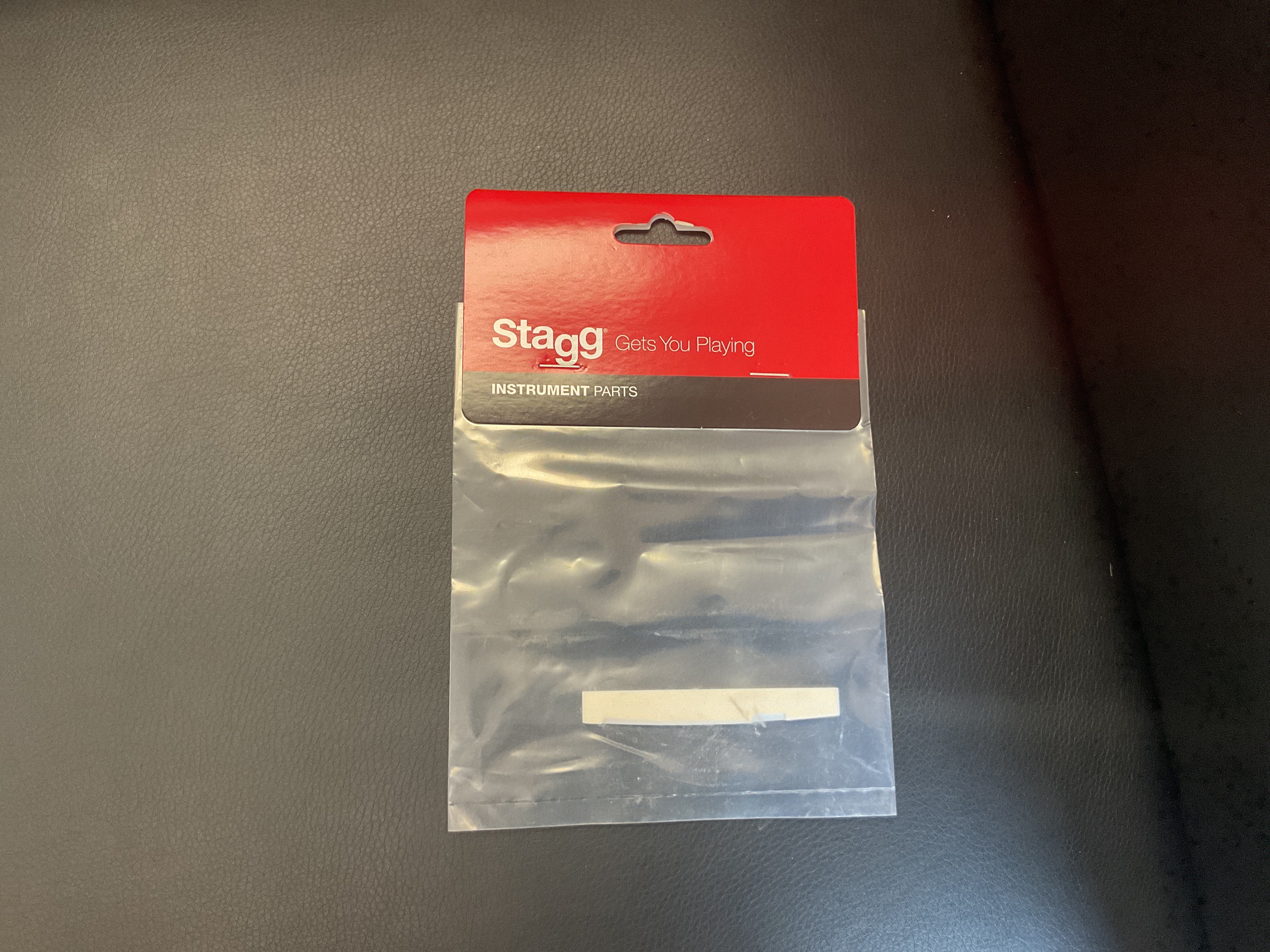 Image of STAGG FOLK PRESLOTTED BONE SADDLE