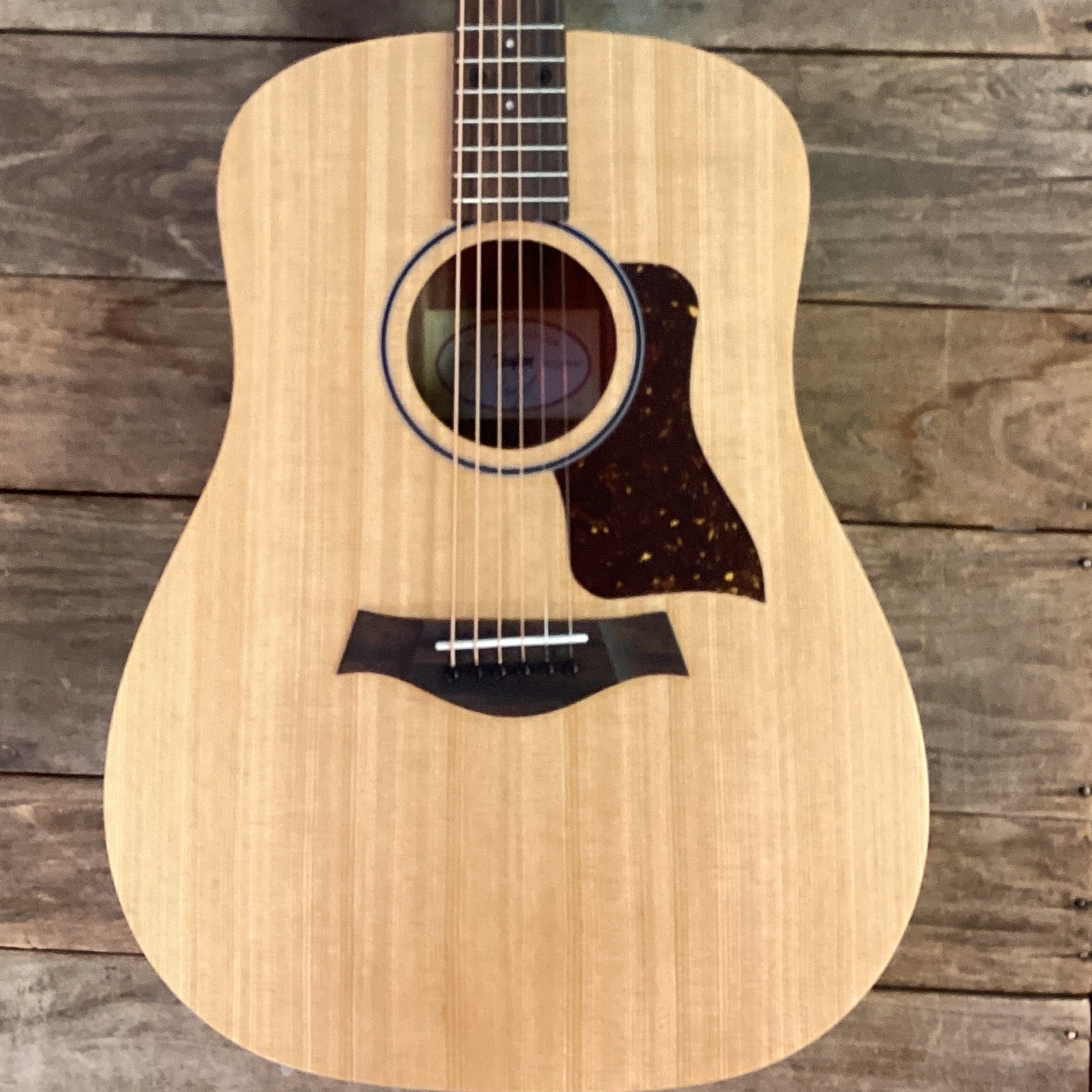 Acoustic guitar on a wooden background