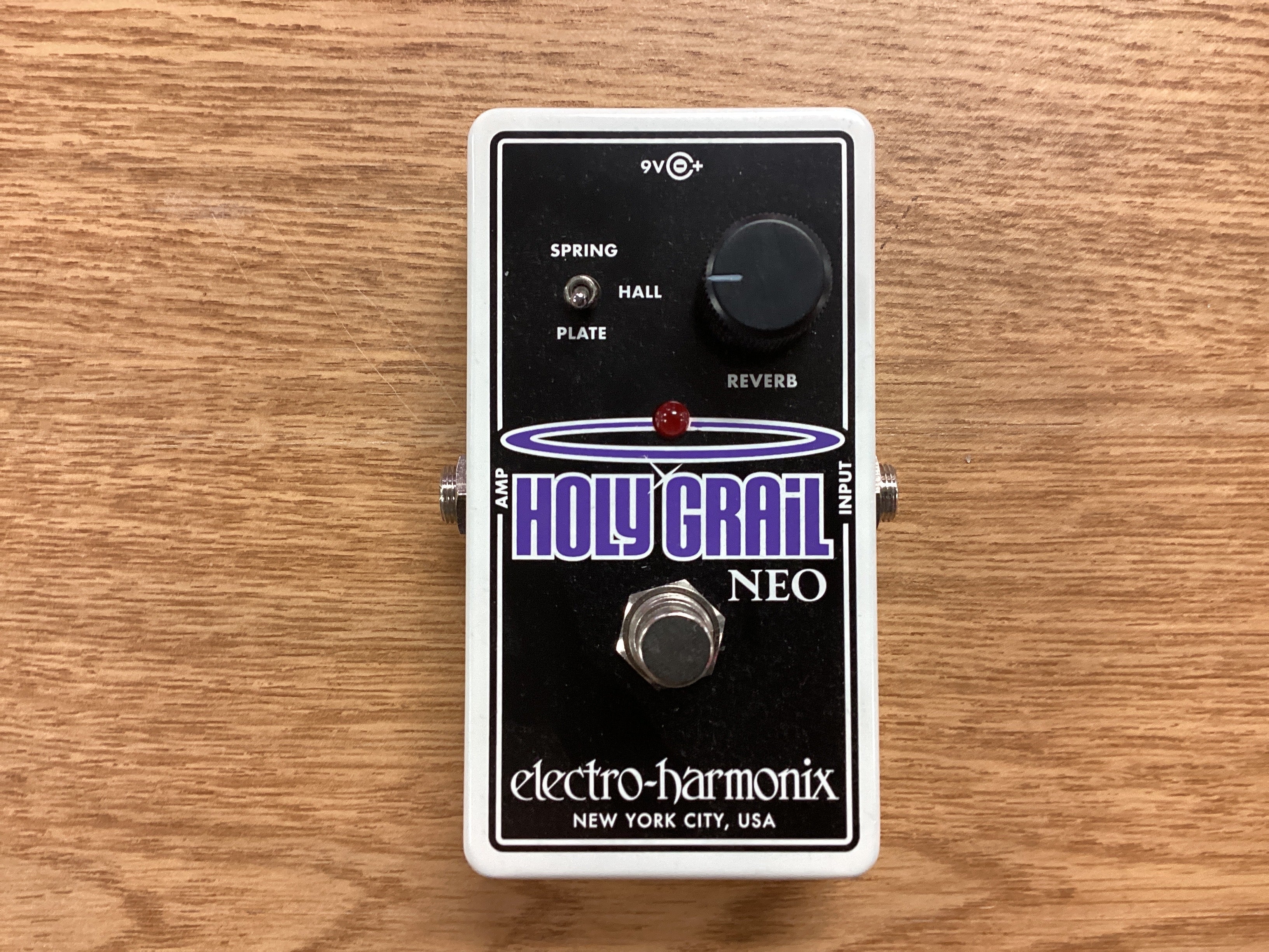 Image of Guitar effects pedal with 'Holy Grail Neo' branding on a wooden surface