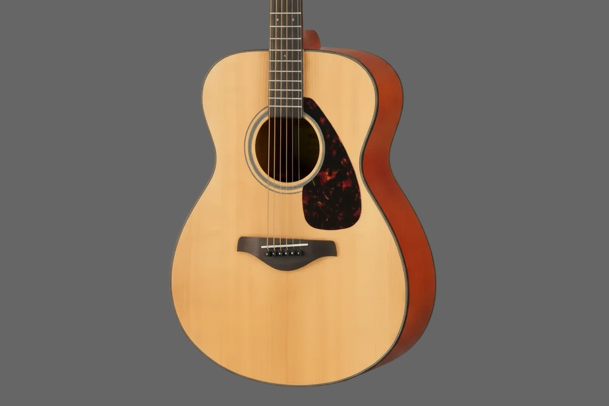 Image of Acoustic guitar with a wooden body and red accent on a gray background