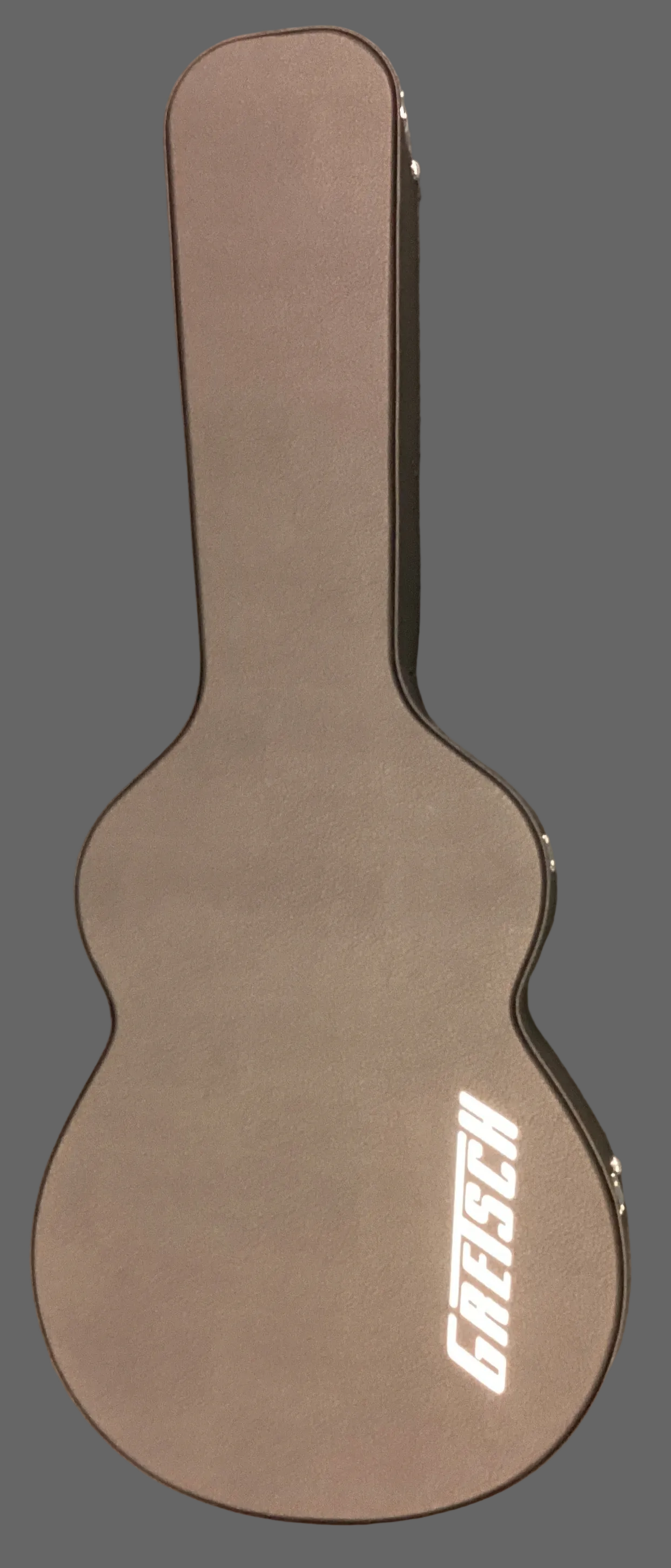 Image of Brown Gretsch guitar case on a gray surface