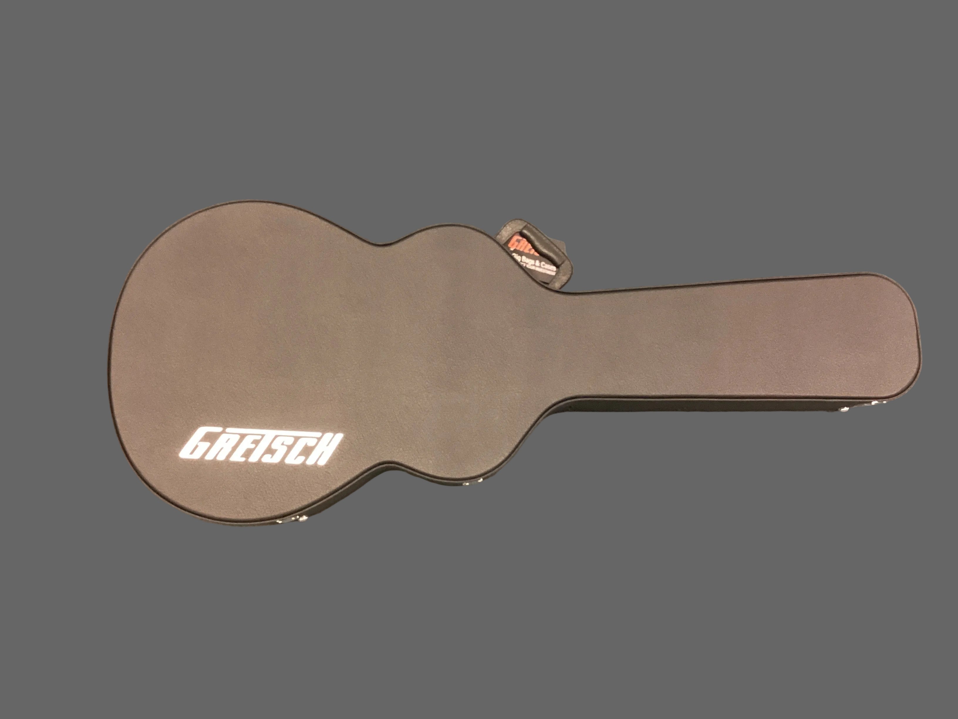 Image of Gretsch guitar case on a gray surface