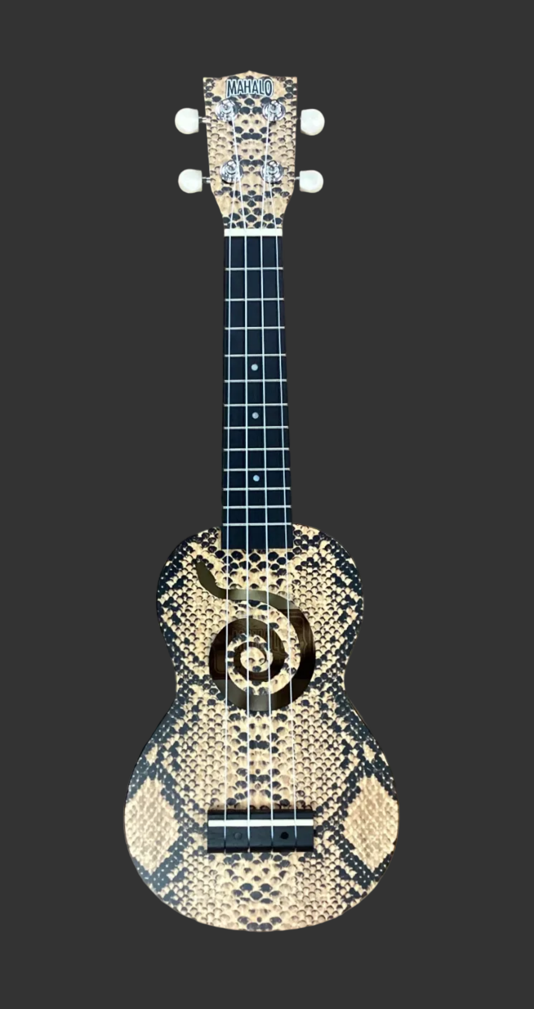Image of Decorative ukulele with snake skin pattern on a black background